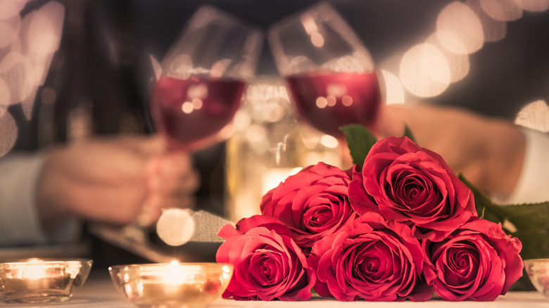 Candlelight dinner with wine and roses