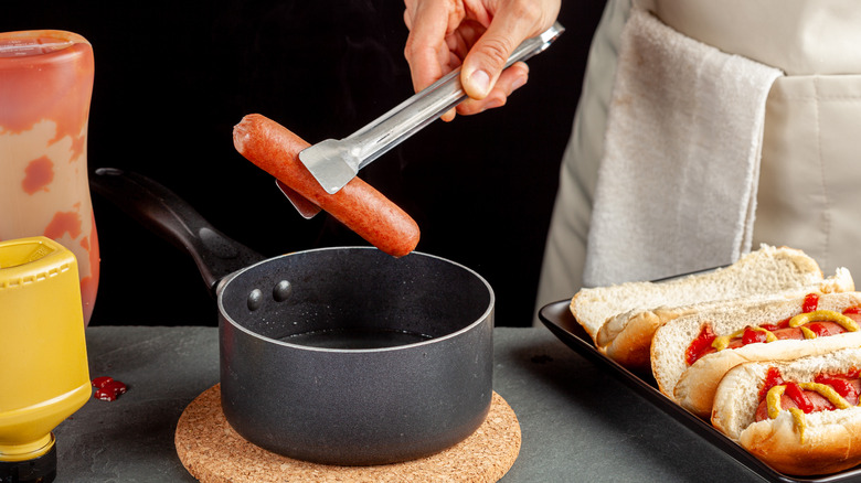 chef boiling hot dogs