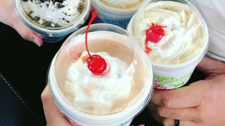 people holding Sonic frozen treats