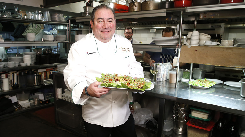 Emeril Lagasse holding food