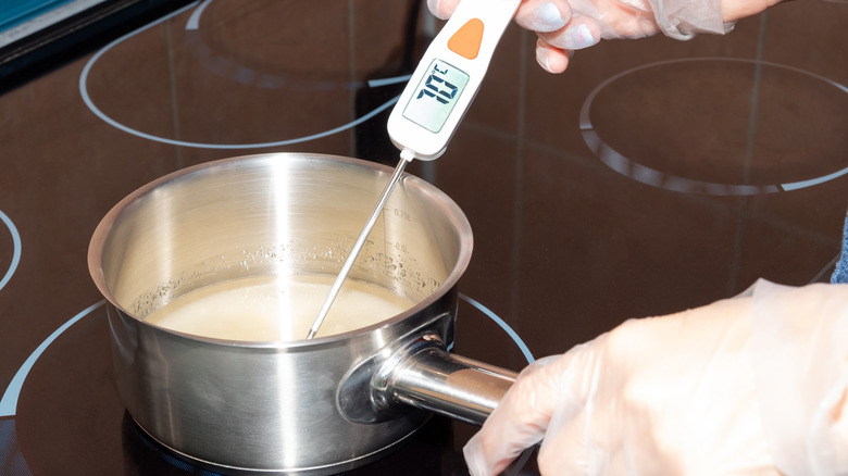 checking a sauce with a thermometer