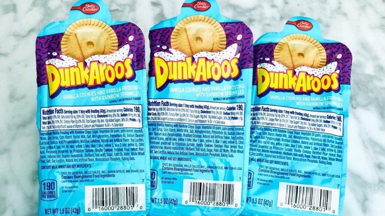 Three packages of colorful Dunkaroos on marble background