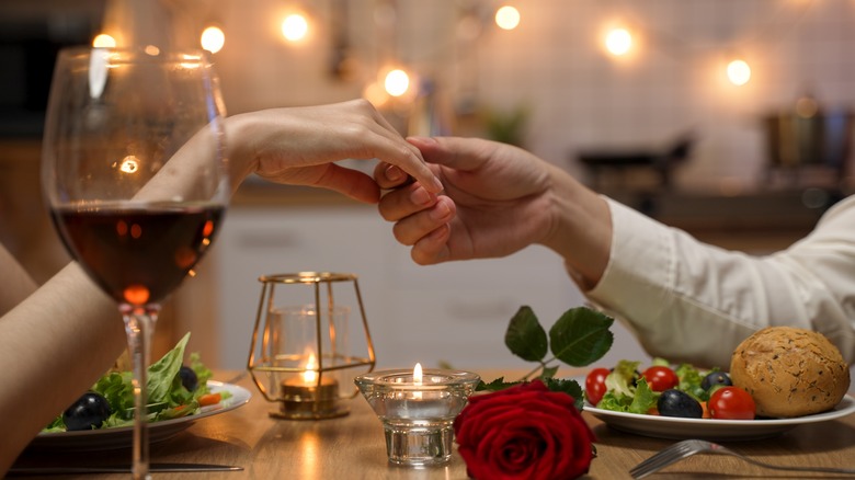 Holding hands during a romantic meal