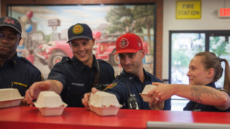 FIrst responders grabbing boxes of firehouse subs