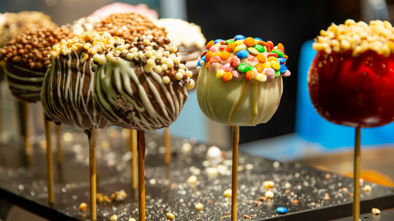 Various candied caramel apples on sticks