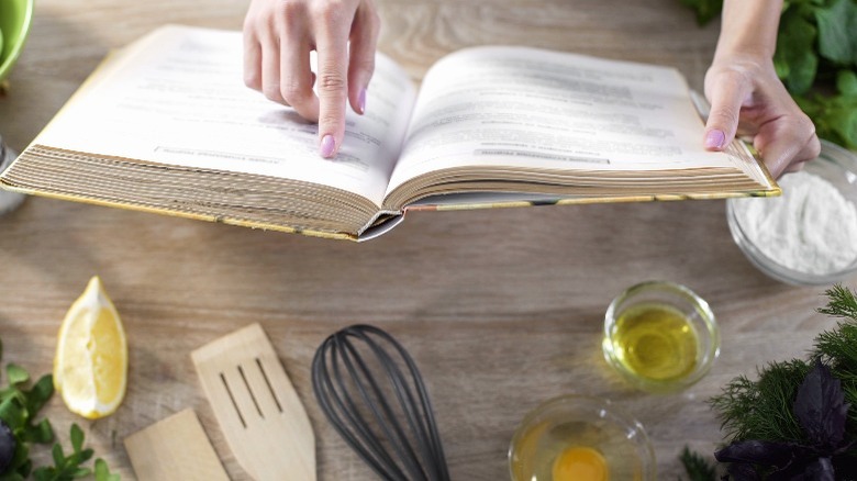 Person holds open recipe book