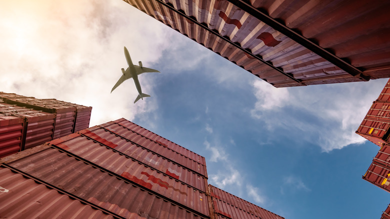 Airplane flying over cargo bins