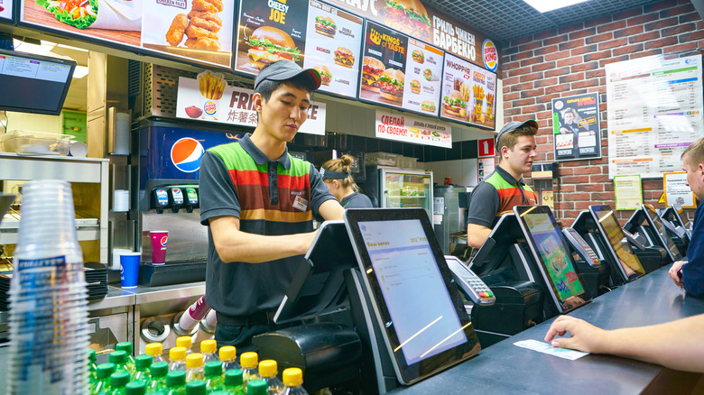 Workers at Burger King taking orders