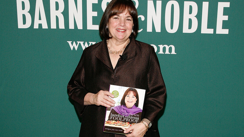 Ina Garten holding a Barefoot Contessa cookbook