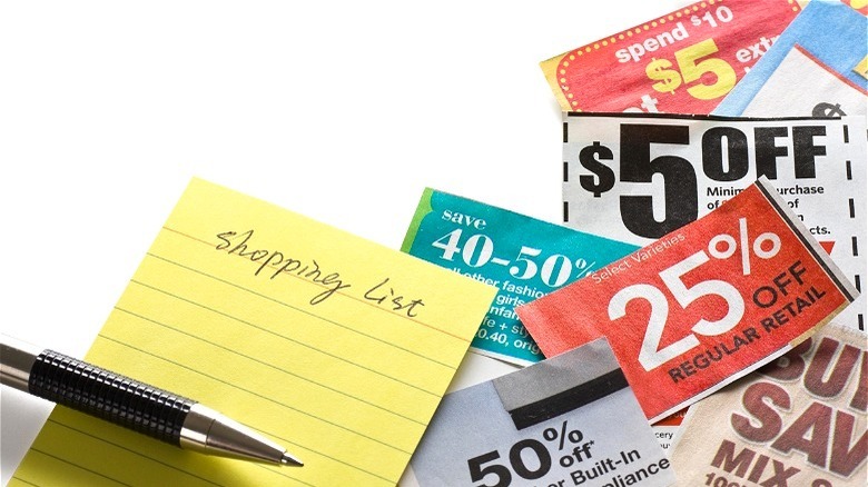 Shopping list with pen and coupons