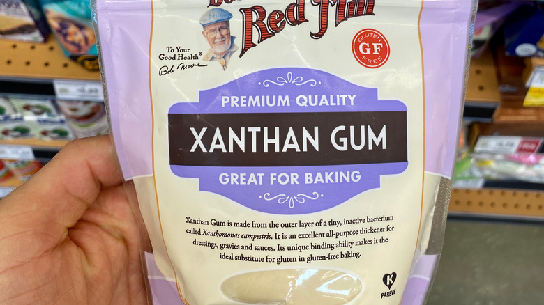 Hand holding bag of xanthan gum