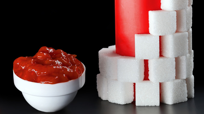 Sugar cubes stacked around ketchup bottle