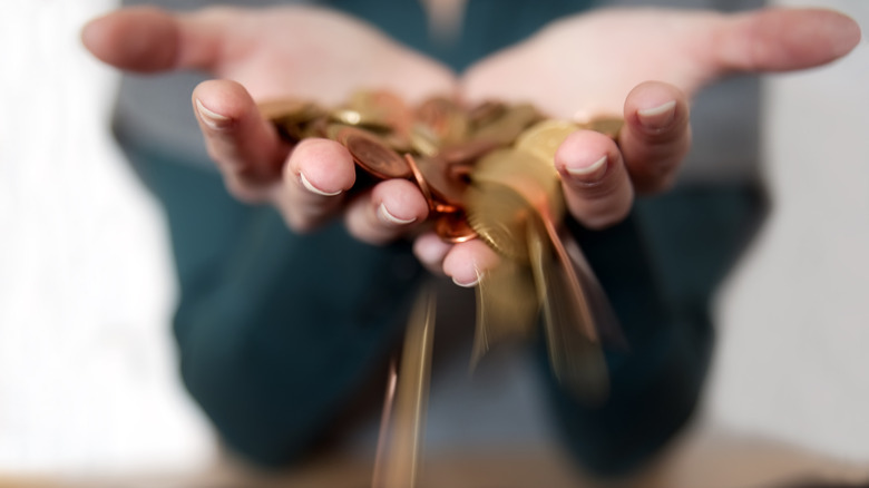 Coins slipping through fingers