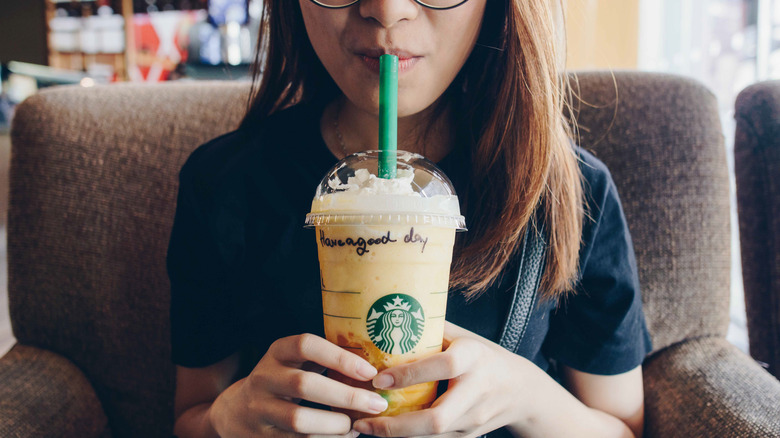 Woman drinking Starbucks drink