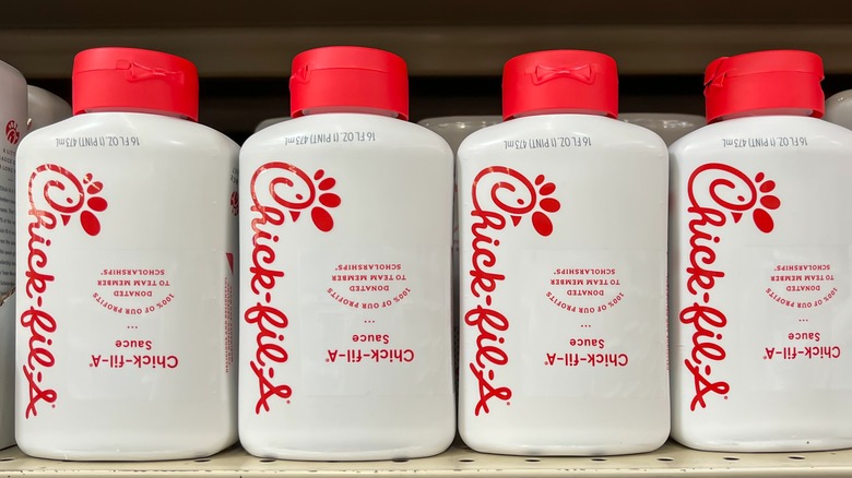 Bottles of Chick-fil-a sauce on a shelf