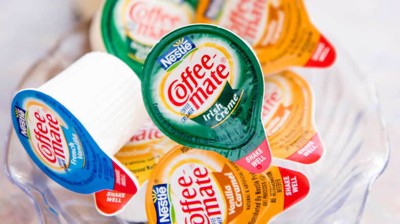 mini individual cups of Coffee Mate creamers in a bowl