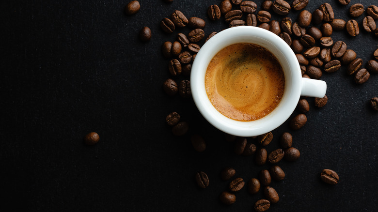 Cup of espresso and coffee beans