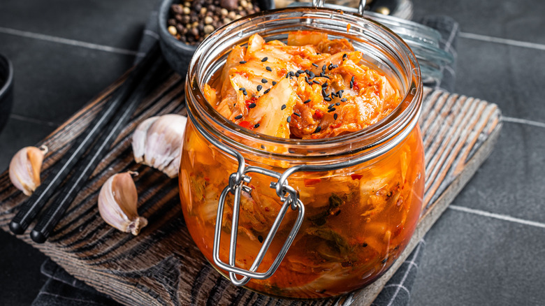 Glass jar of homemade kimchi on counter