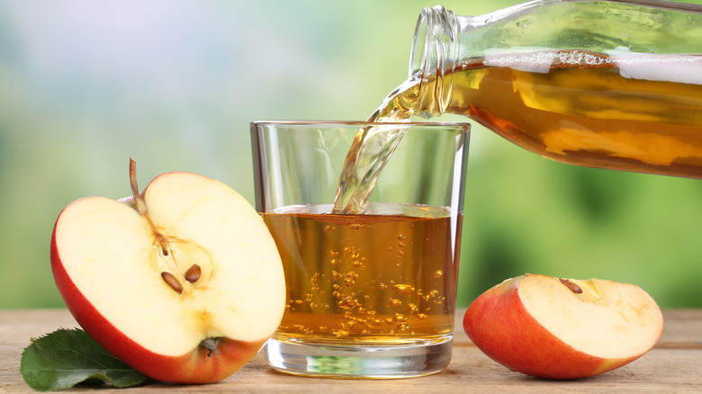 pouring apple cider into glass