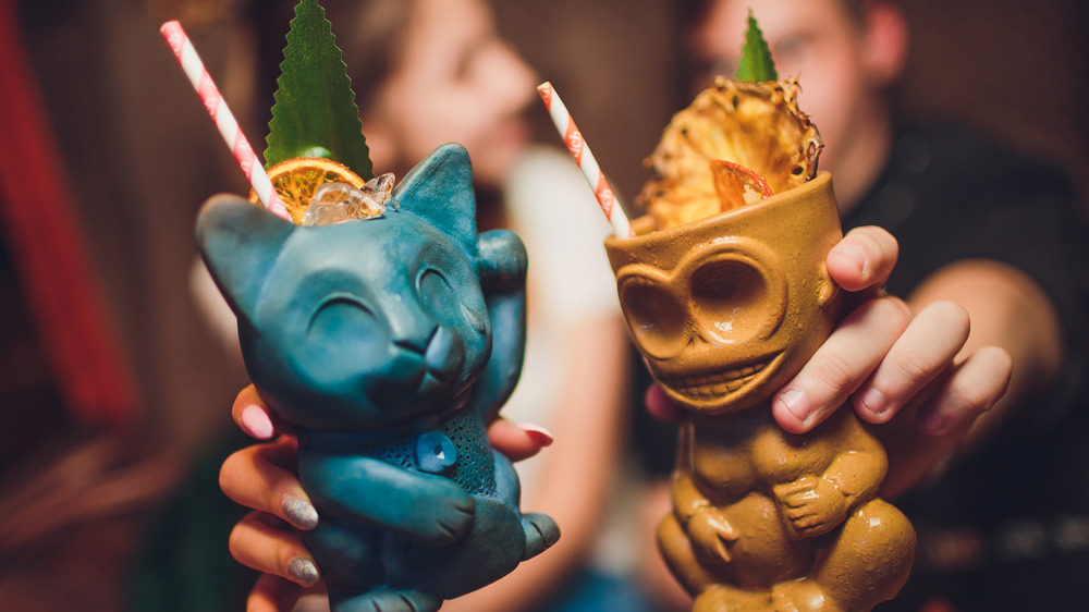 Tiki cocktails in cat and monkey mugs