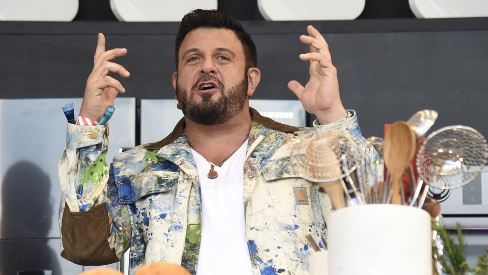 Adam Richman of Man v. Food in colorful jacket