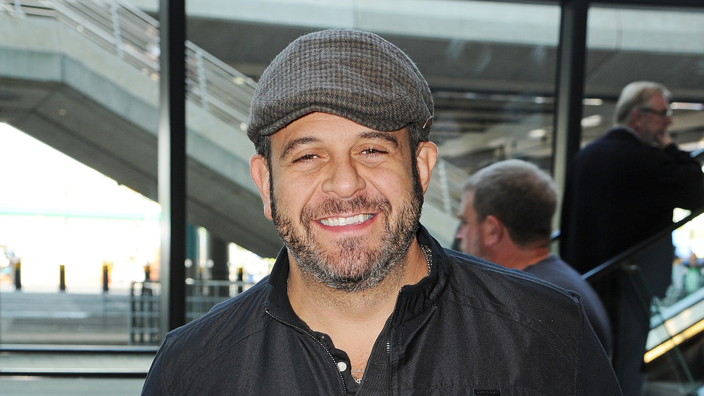 Adam Richman of Man v. Food wearing a hat