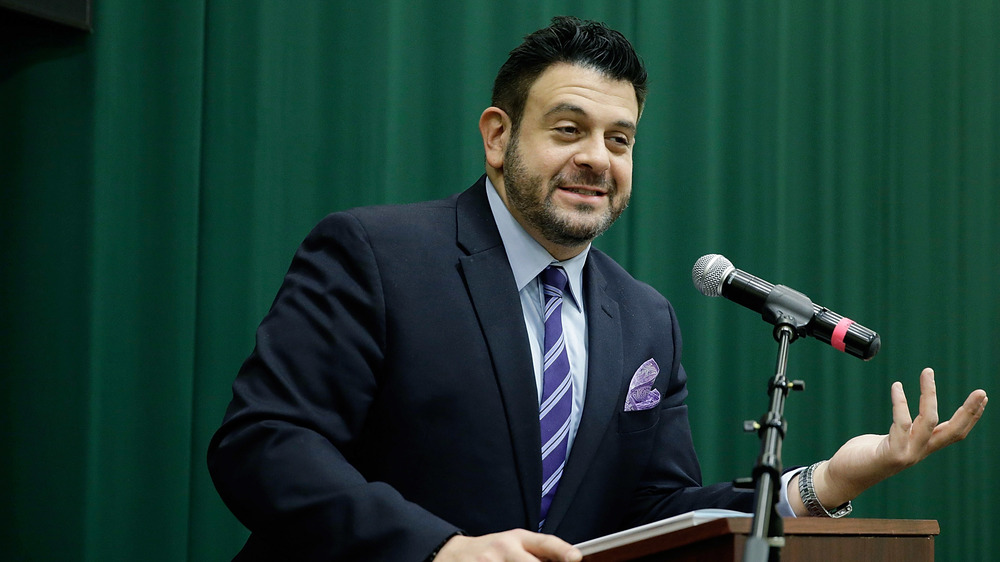 Adam Richman of Man v. Food on a podium