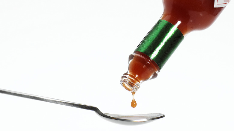 tabasco sauce dropping onto spoon