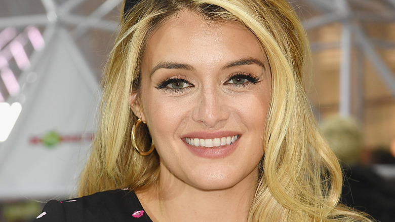 Daphne Oz with hair down and wide smile