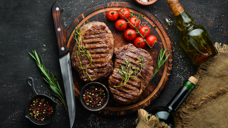 cooked steak on cutting board