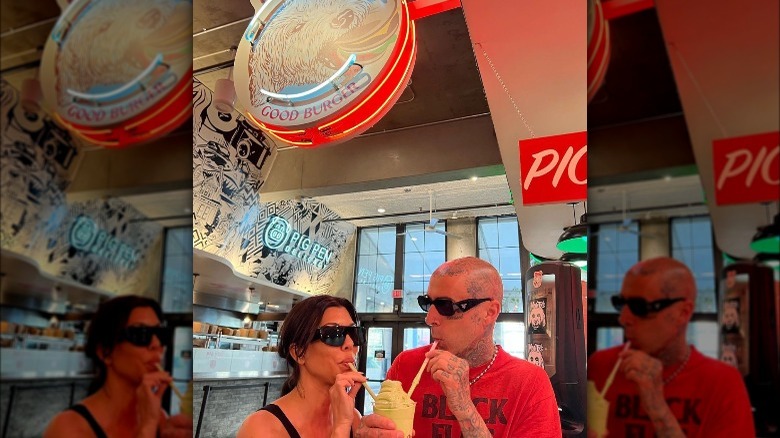 Travis Barker and Kourtney Kardashian sharing a milkshake at Monty's