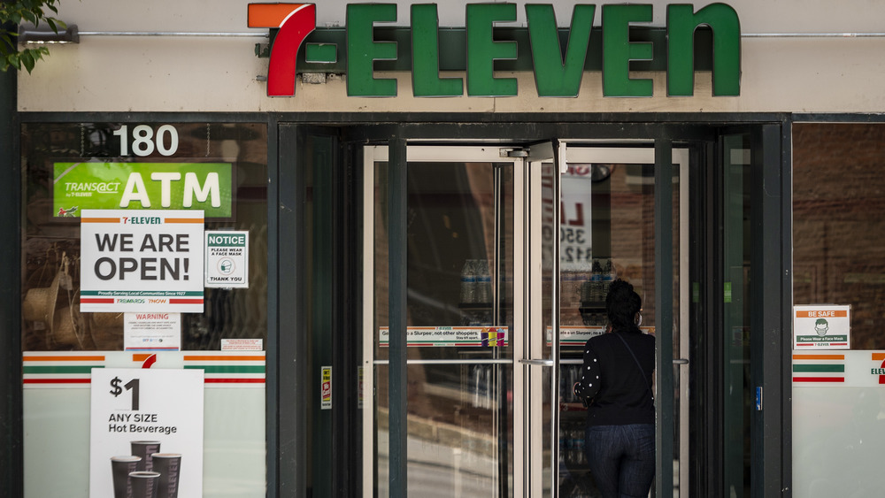 Woman entering revolving door at 7-Eleven