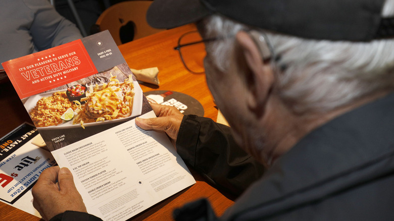 Man reading an Applebee's menu
