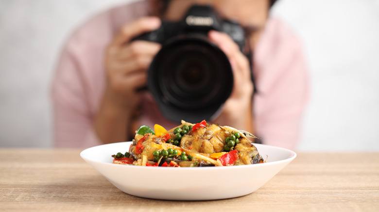 Photographer taking pictures of food