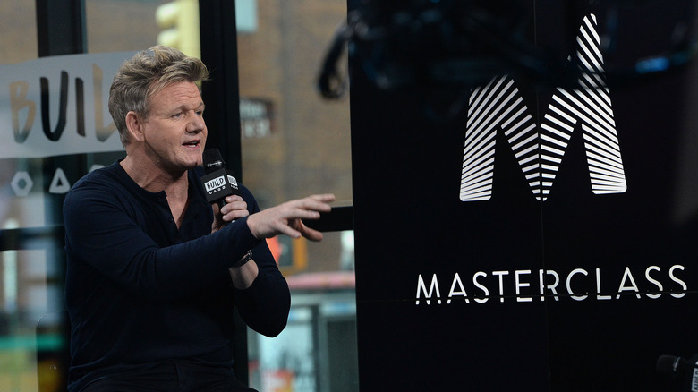 Gordon Ramsay speaking in front of the MasterClass sign