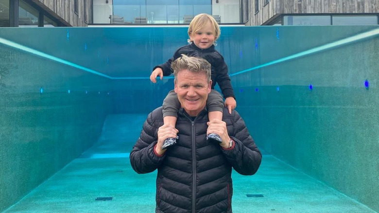 Gordon Ramsay and son in front of swimming pool