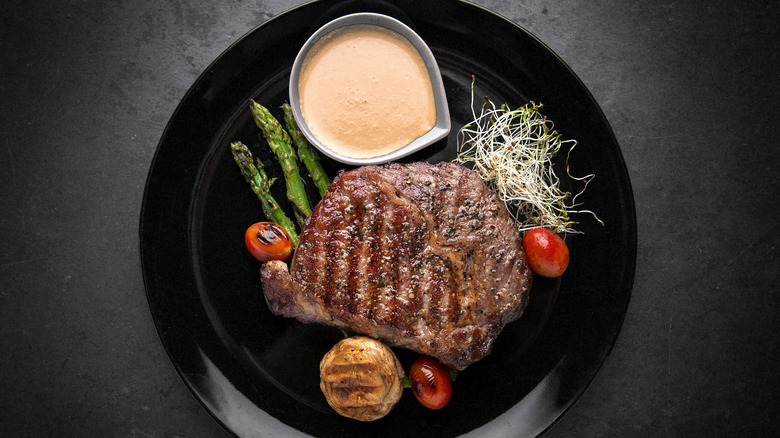 steak meal with asparagus and sauce