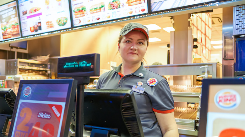 Female Burger King worker wearing grey uniform