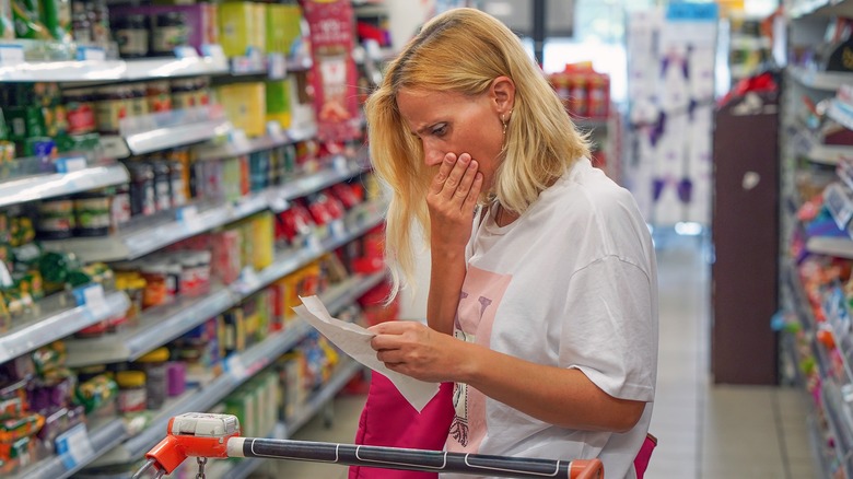 Customer looks shocked in grocery aisle 