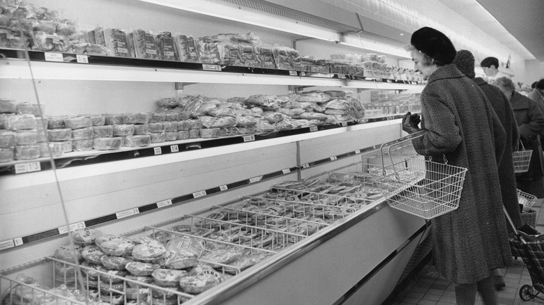 A customer in supermarket refrigerated section 