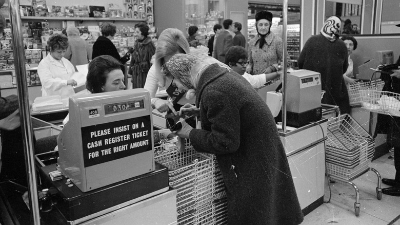 Customer paying at grocery register 