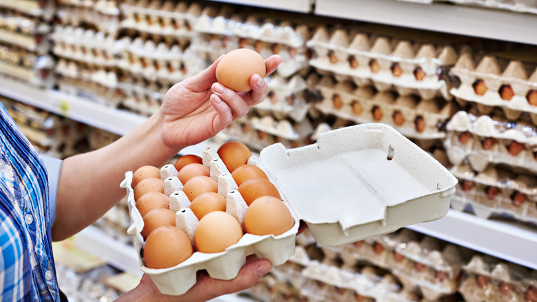 Shopper holding an egg carton 