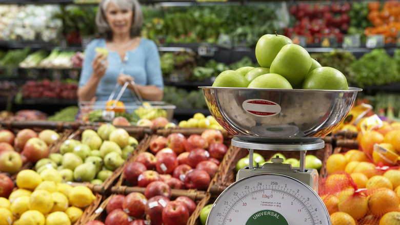 Apples on a scale in produce section