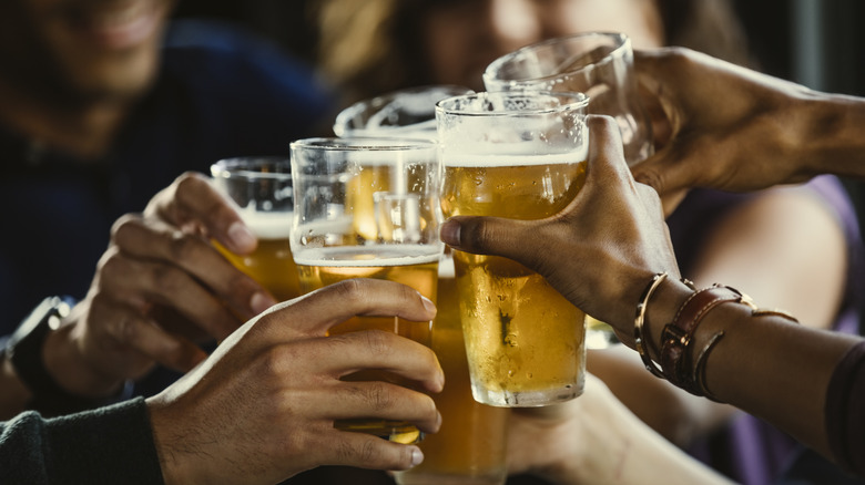 Group of people toasting glasses of beer