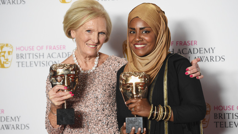 judge Mary Berry and 2015 winner Nadiya Hussain posing with television award trophies after winning The Great British Baking Show