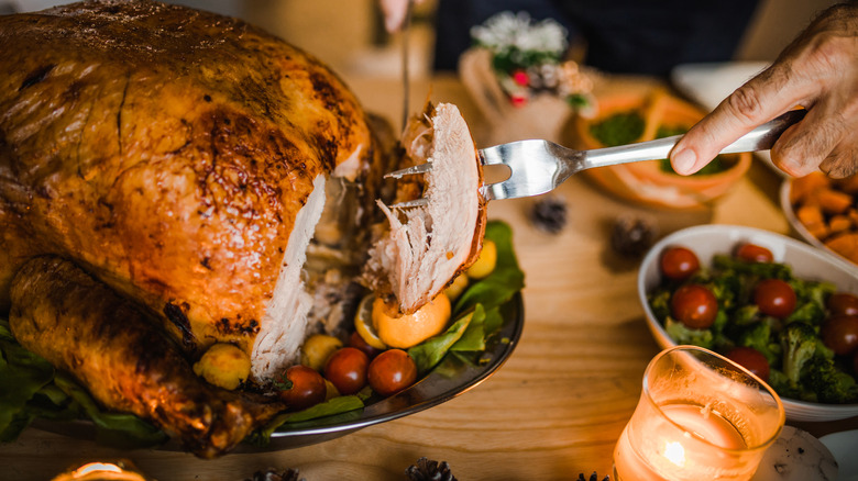 Person carving a turkey