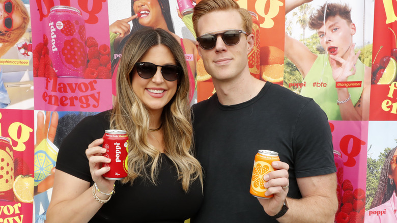 Allison and Stephen Ellsworth pose with cans of Poppi