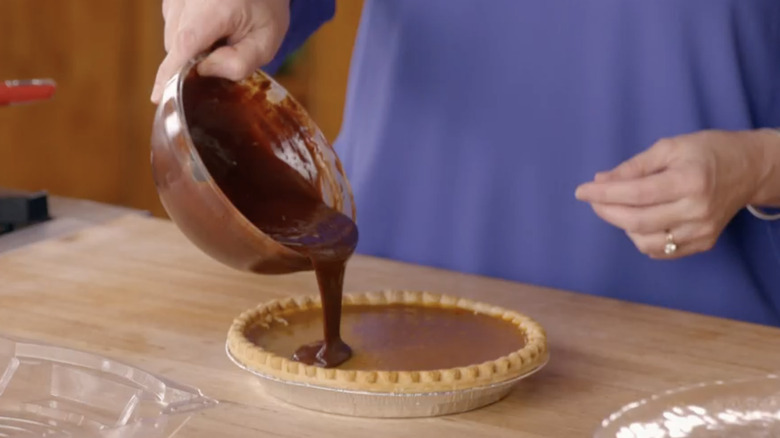 Pouring ganache on pumpkin pie