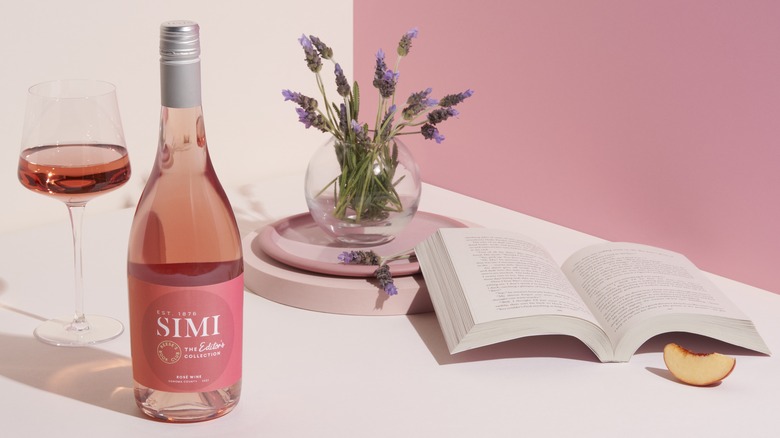 bottle of rose Simi wine with book and plant