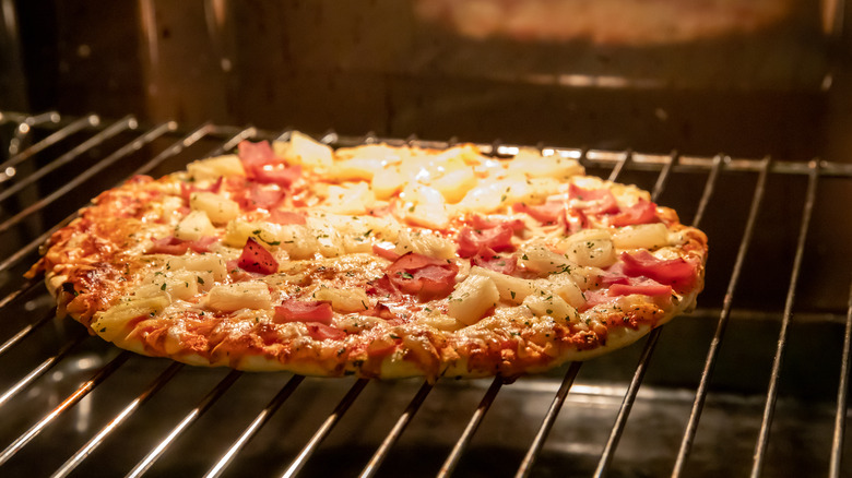 frozen pizza cooking on an oven rack